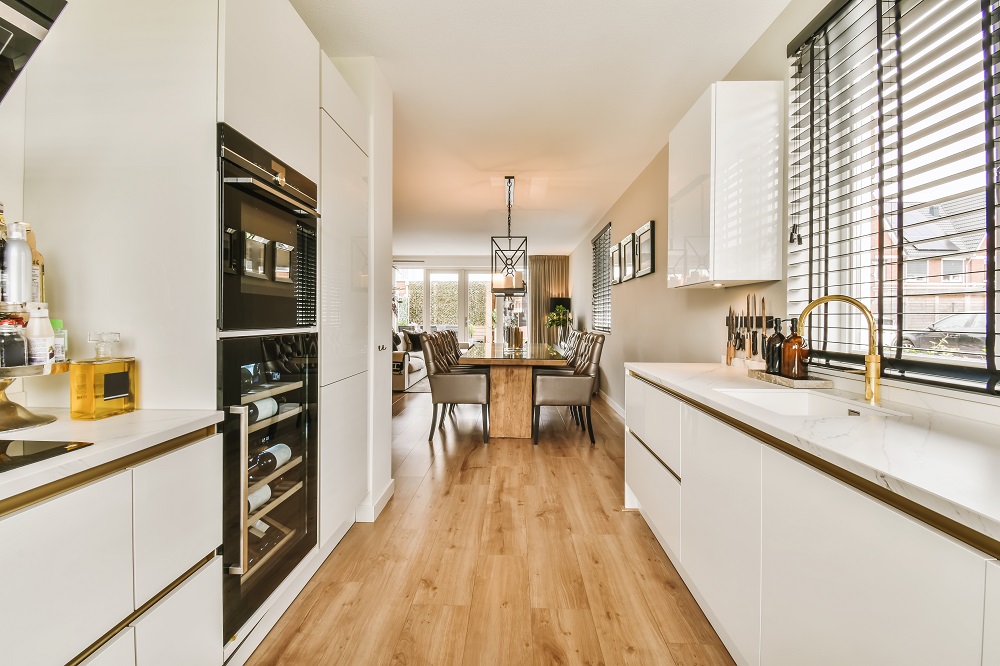 a kitchen with white cabinets and a dining room table