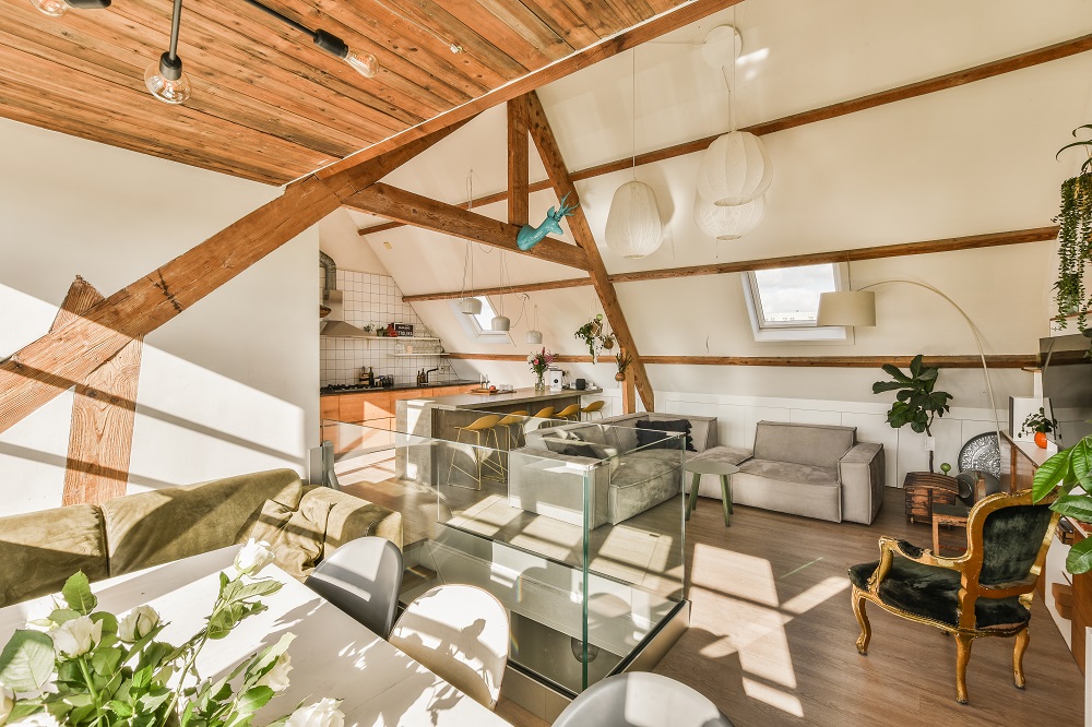 a living room with a glass table and a kitchen